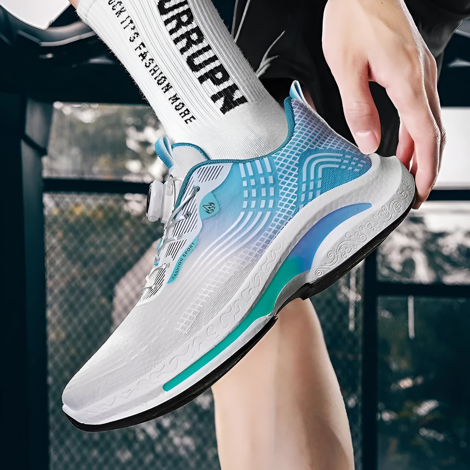 Men's white and blue low-top sneaker with a rotating buckle and mesh upper on a rubber sole.