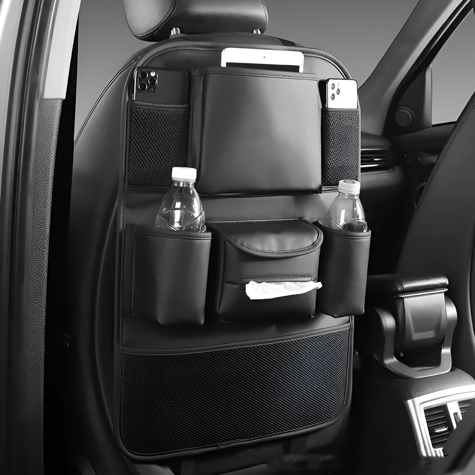 Black PU leather car seat back storage bag hanging on a grey car seat headrest.