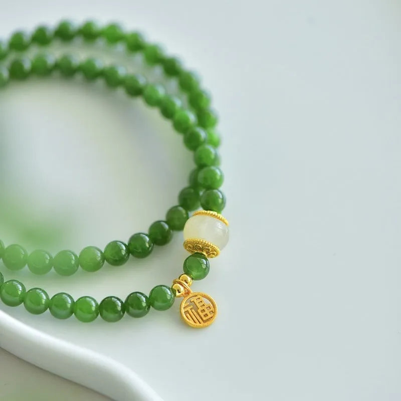 Natural Hetian jade double circle bracelet with 6mm beads and a carved fu character charm.