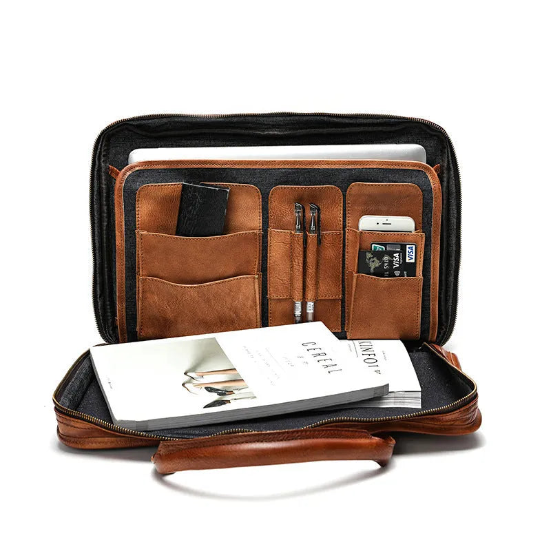 Brown vintage leather men's briefcase with soft handle, showing organised internal pockets for laptop and camera.