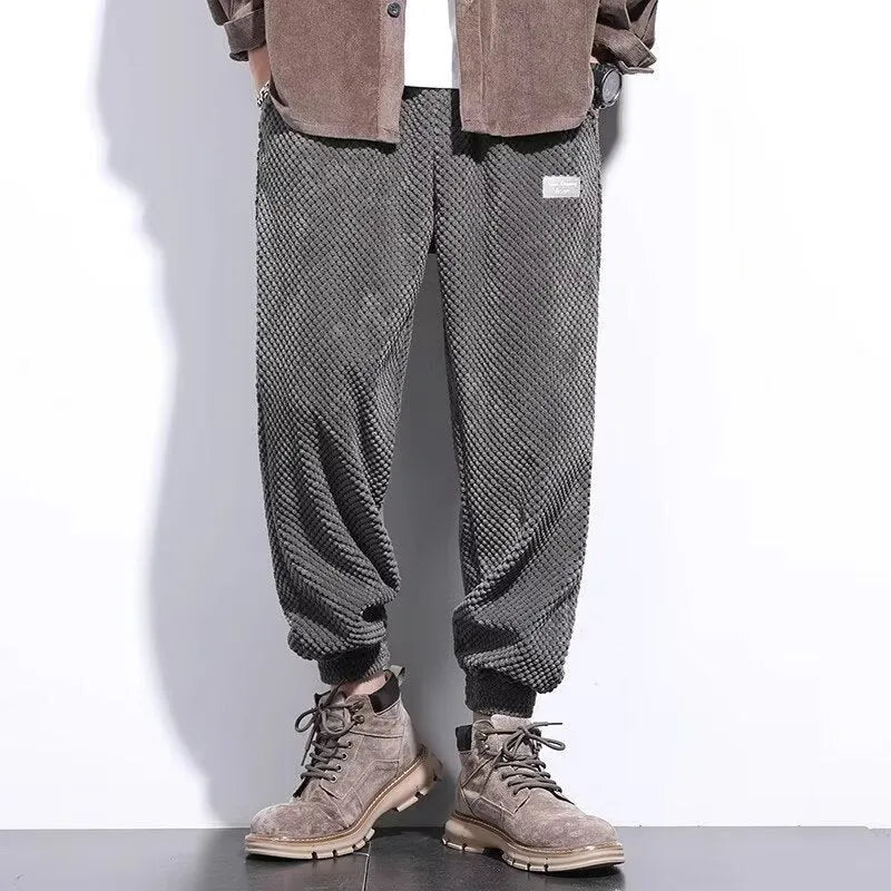 Men's grey straight leg sweatpants with an ankle tie strap, laid flat.