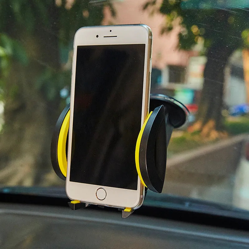Red ABS suction cup U-shaped mobile phone bracket with open clamp arms on a car dashboard.