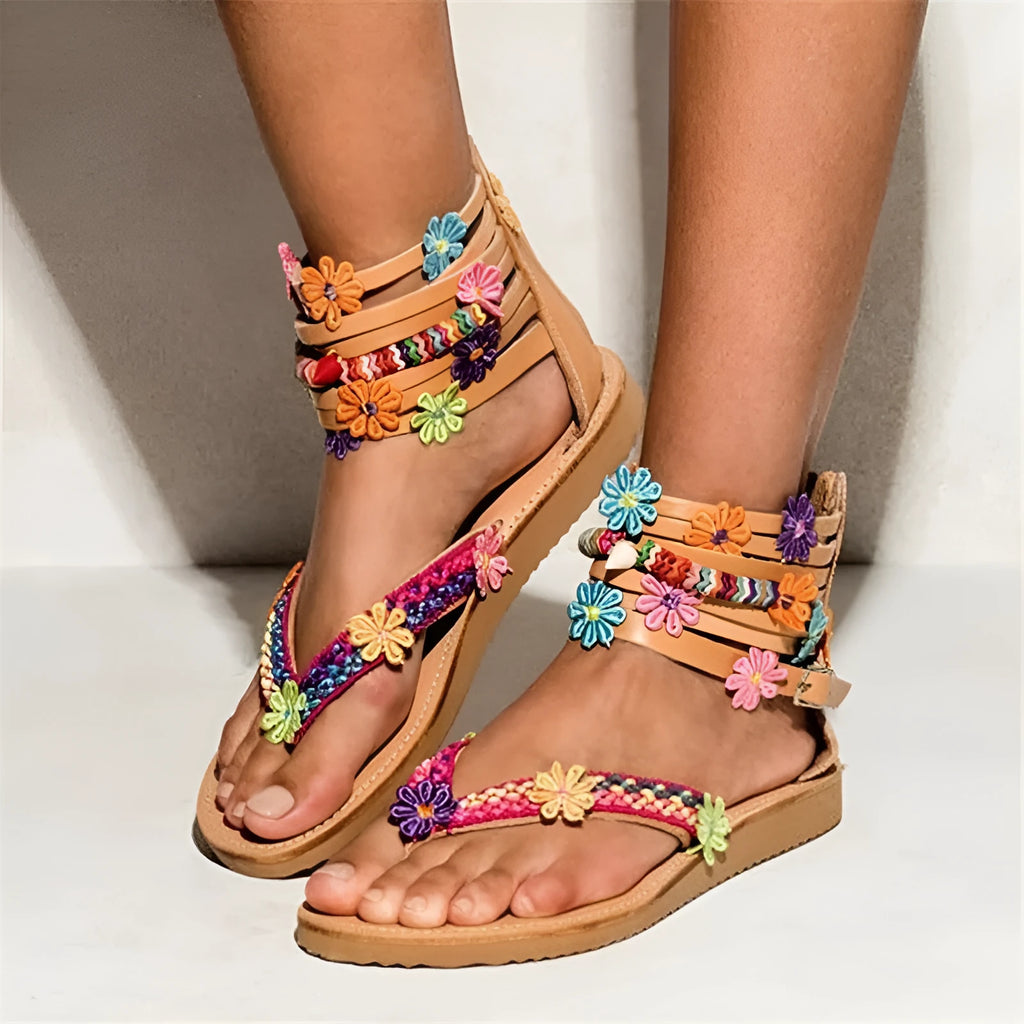 Ethnic style beaded petal sandals with floral design and round toe on a white background.