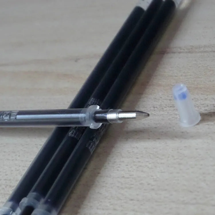 Automatic fade and disappear pen set showing pen holder, case, and eight refills on a notepad.