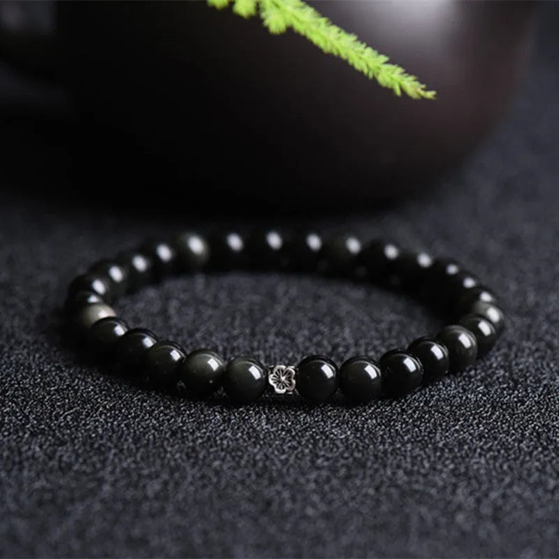 Natural black obsidian bracelet with S925 sterling silver flower charm and dragon phoenix decorations on wrist