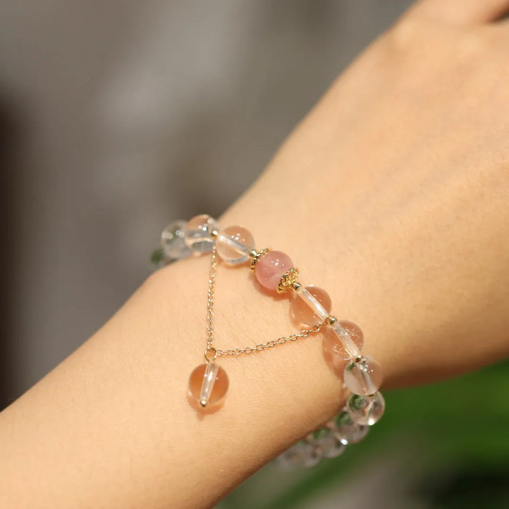 White and pink crystal bracelet with geometric Chinese design and cat eye obsidian elements