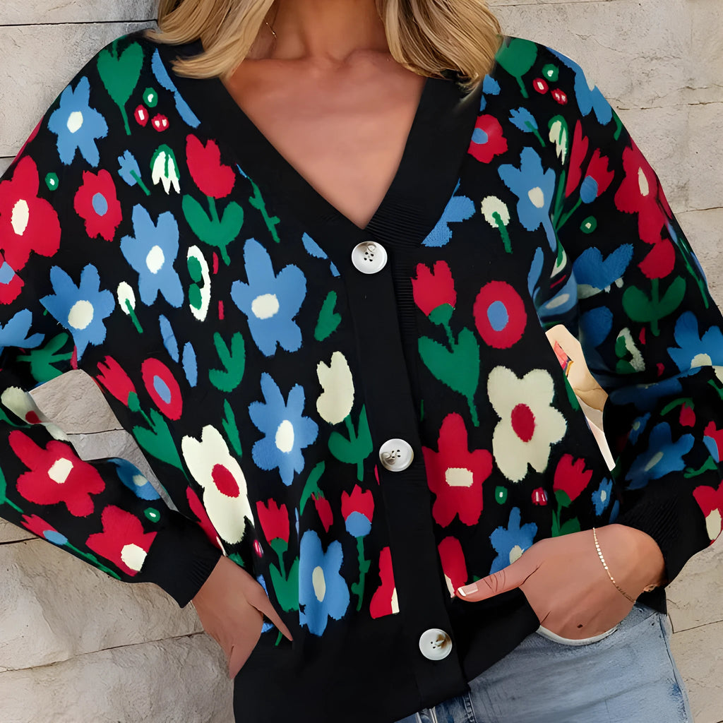 Black floral print V-neck button cardigan sweater with long sleeves and colour-block detail, laid flat