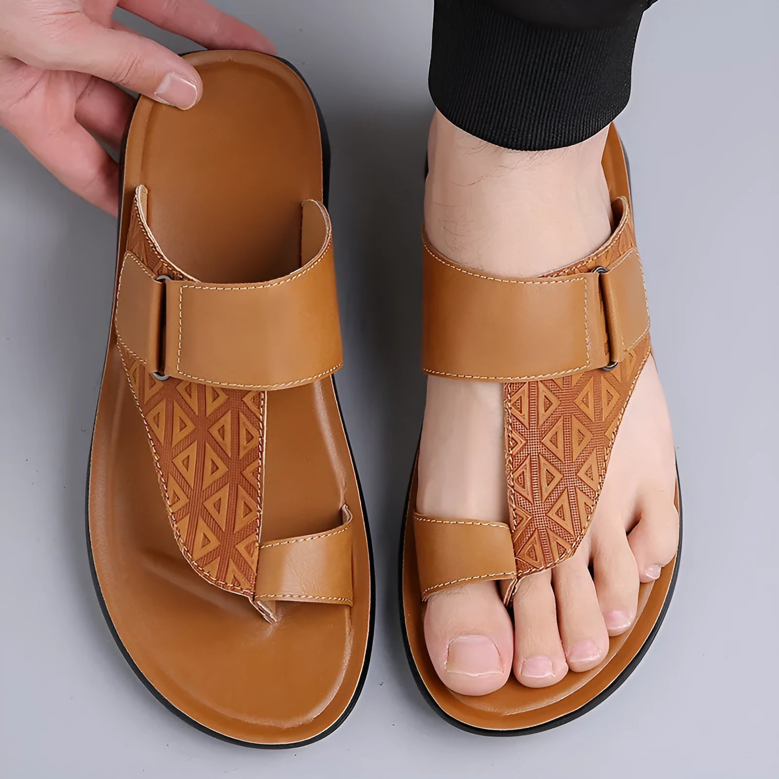 Men's white open-toe cowhide leather slippers with a rubber sole on a casual background