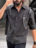 Men's black regular-fit polyester button-up shirt with a collar on a hanger.