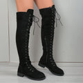 Black lace-up over-the-knee boots with round toe and flat rubber sole on a neutral background.