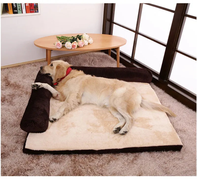 Large grey corduroy dog sofa bed with raised sides on a wooden floor