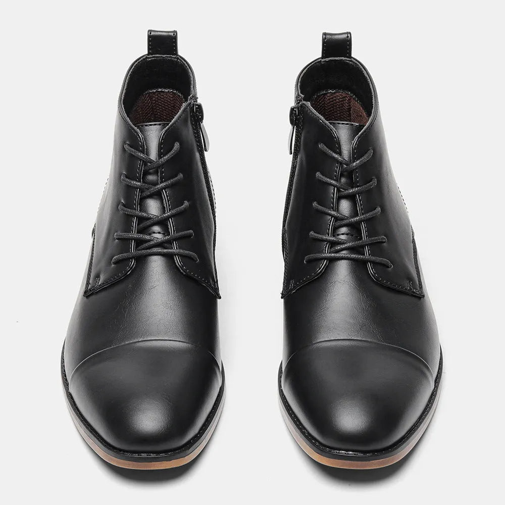 Men's brown Chelsea ankle boots with a visible side zipper on a wooden sole.