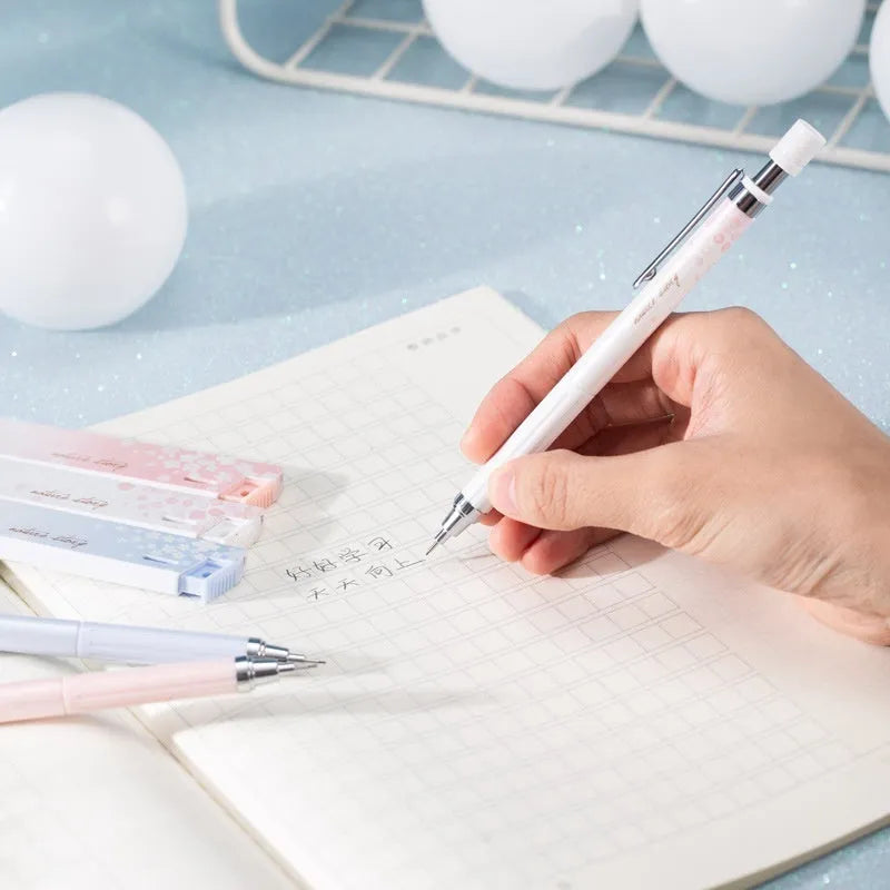 Cartoon sakura design automatic pencil set with three pencils and boxes of HB refills.