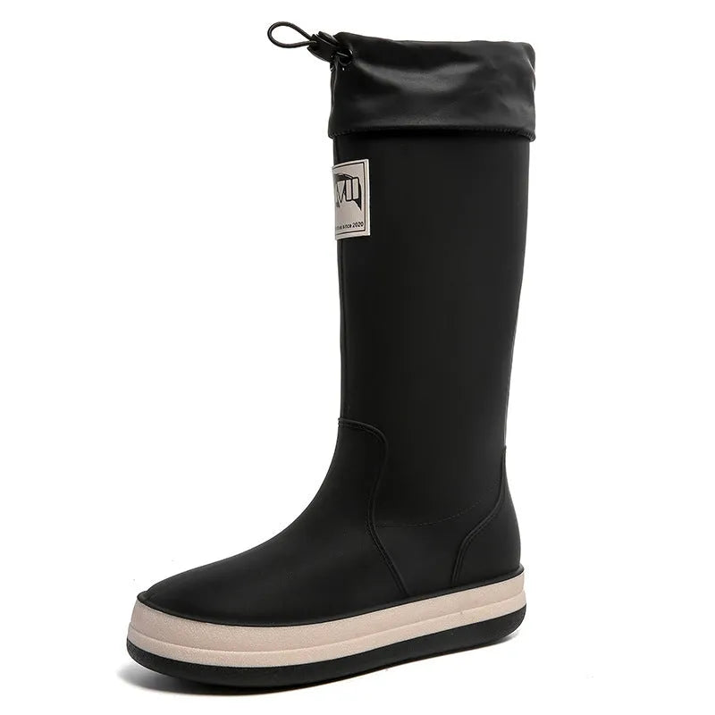 PVC waterproof high tube rain boots in beige, black, green, and red colours on a white background.