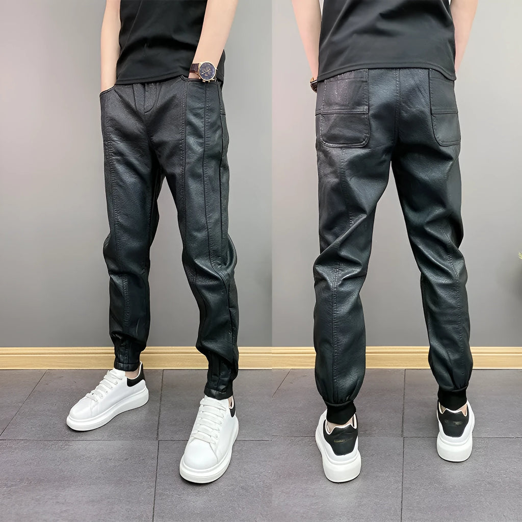 Black slim-fit waterproof motorcycle trousers in artificial leather with mid-rise waist and tapered leg
