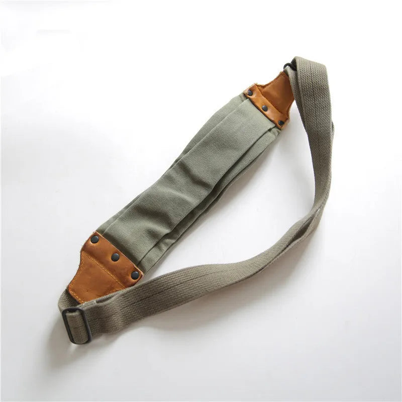 Green military style chest bag made from canvas with leather accents and adjustable shoulder straps