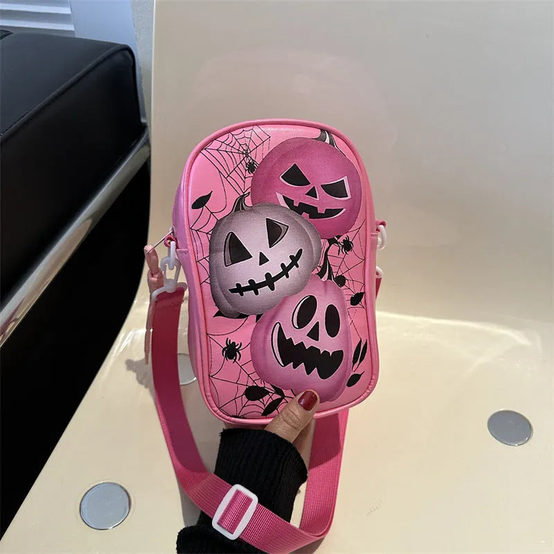 Black mini square crossbody bag with orange cartoon pumpkin, white ghost, and black bat graffiti print.