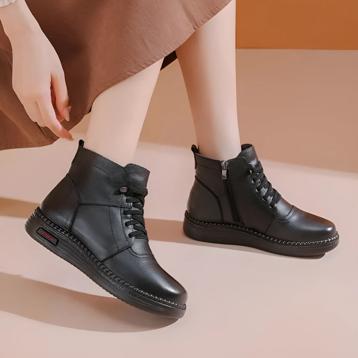 Pair of black cowhide ankle boots with side zipper, platform mid heel, and wool fleece lining visible at the top.