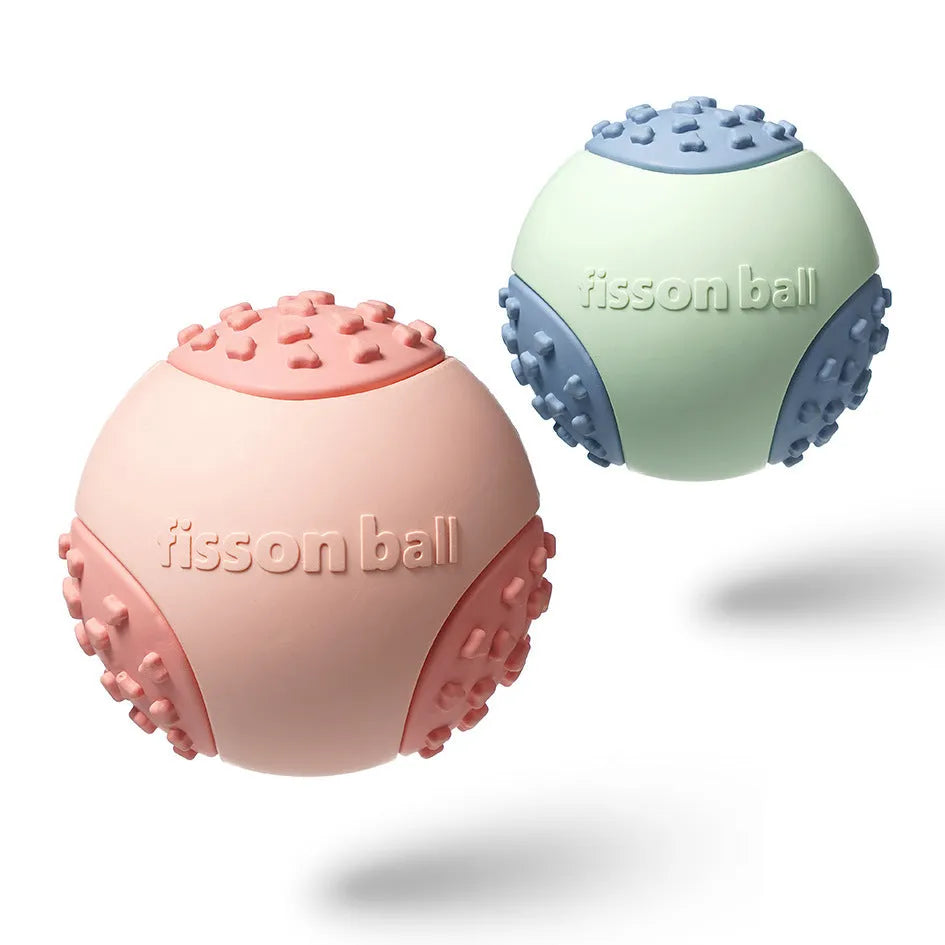 Green rolling ball dog toy for small medium breeds on a floor.