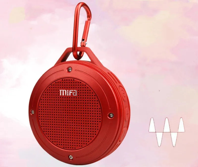 Portable Bluetooth speaker in grey silicone case with button controls, USB port, and compact size