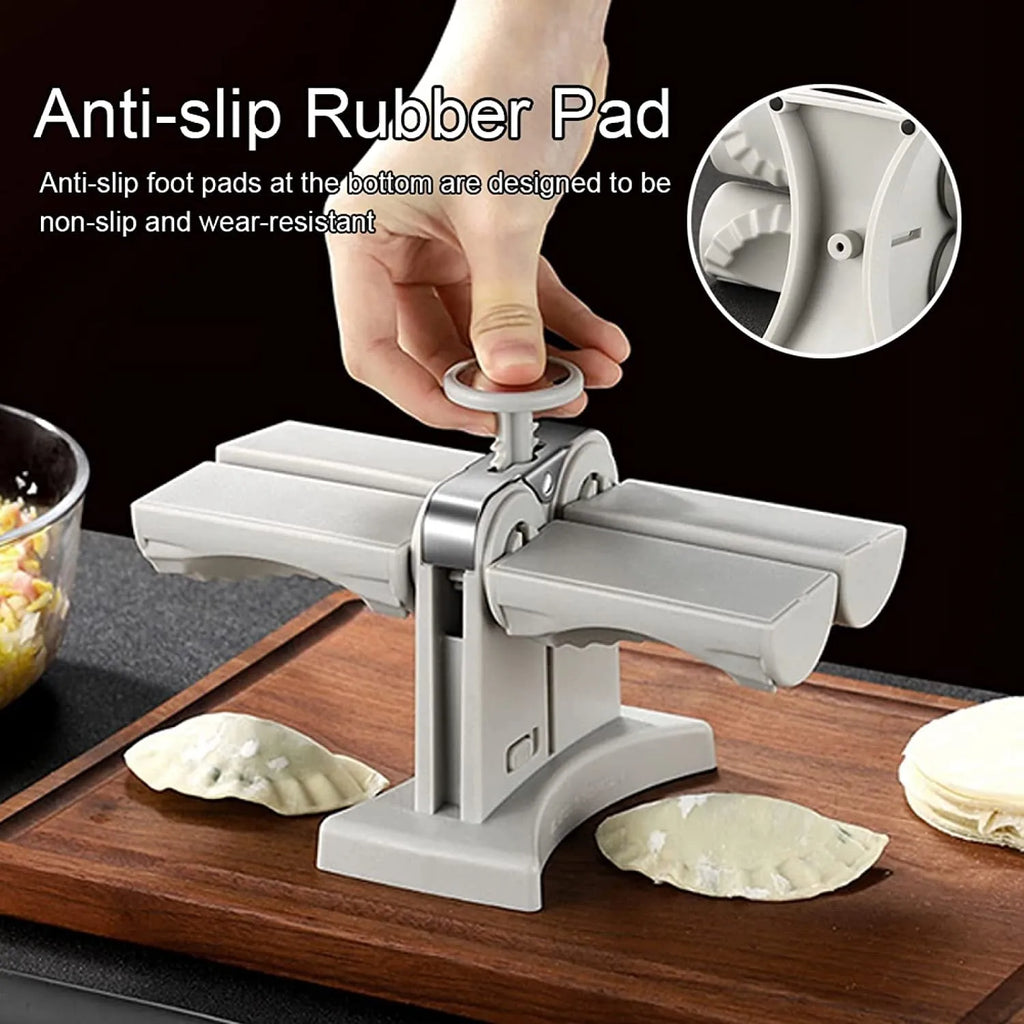 White double-head manual dumpling maker with anti-slip rubber base on a kitchen counter.