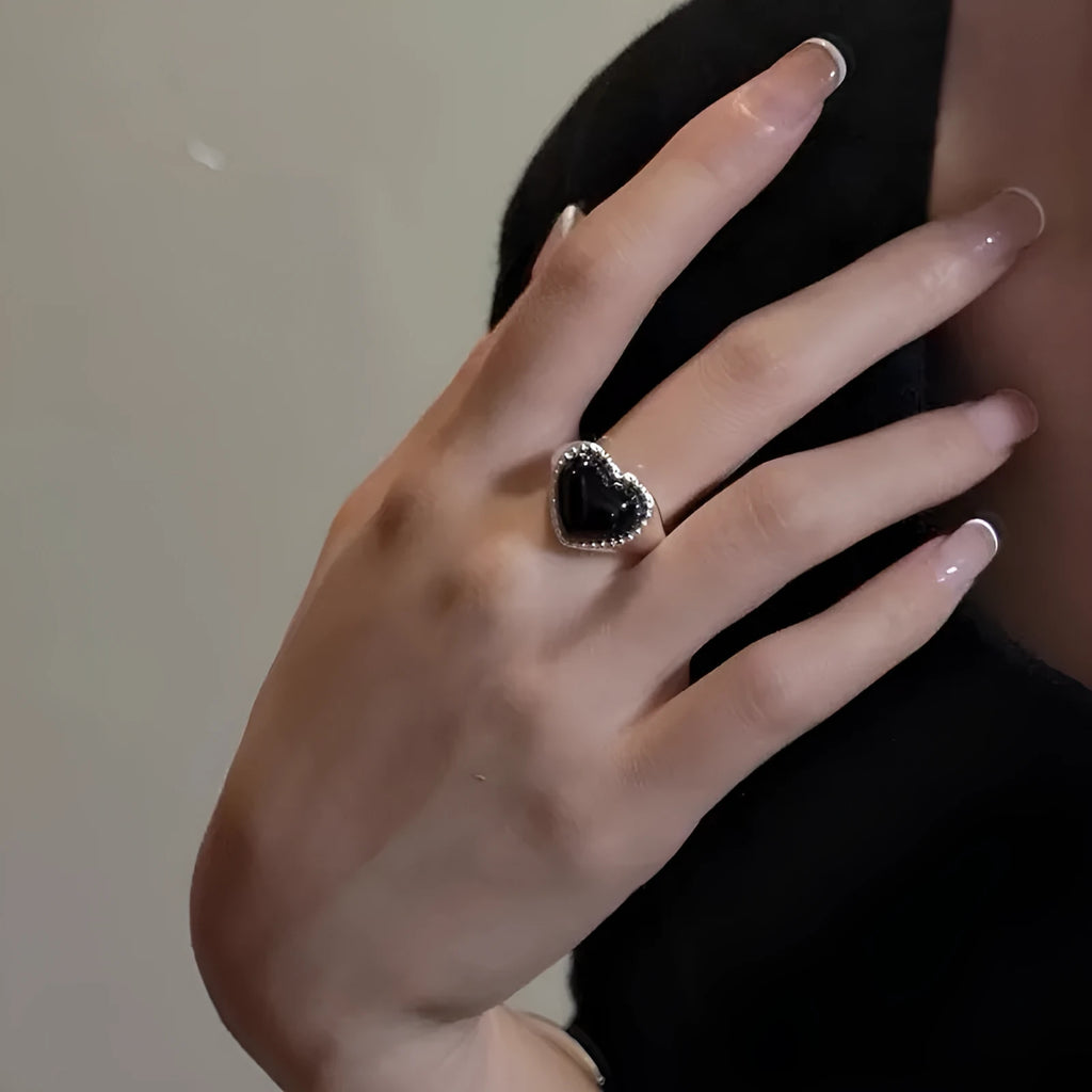 Sterling silver adjustable ring with black agate heart centrepiece on finger