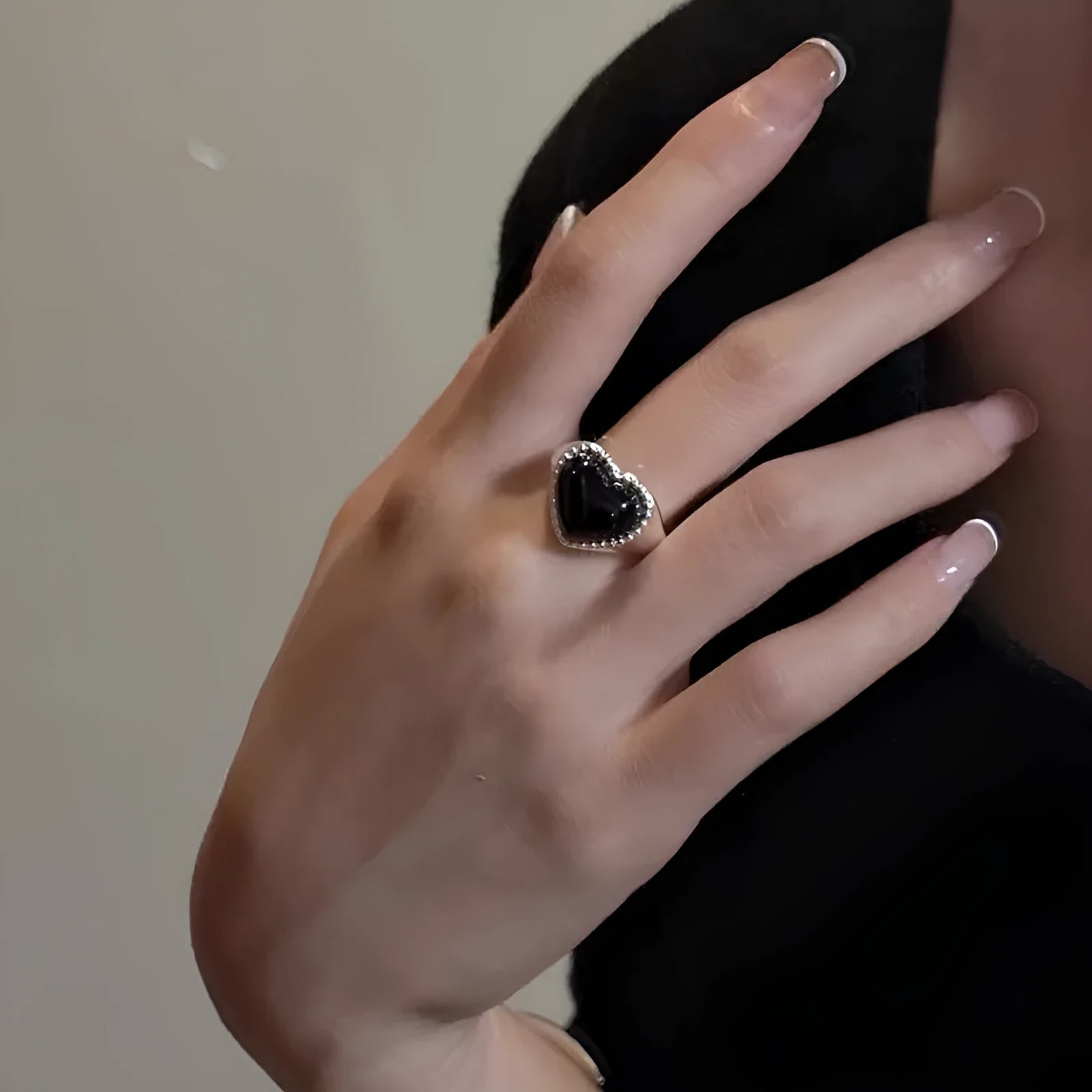 Sterling silver adjustable ring with black agate heart centrepiece on finger