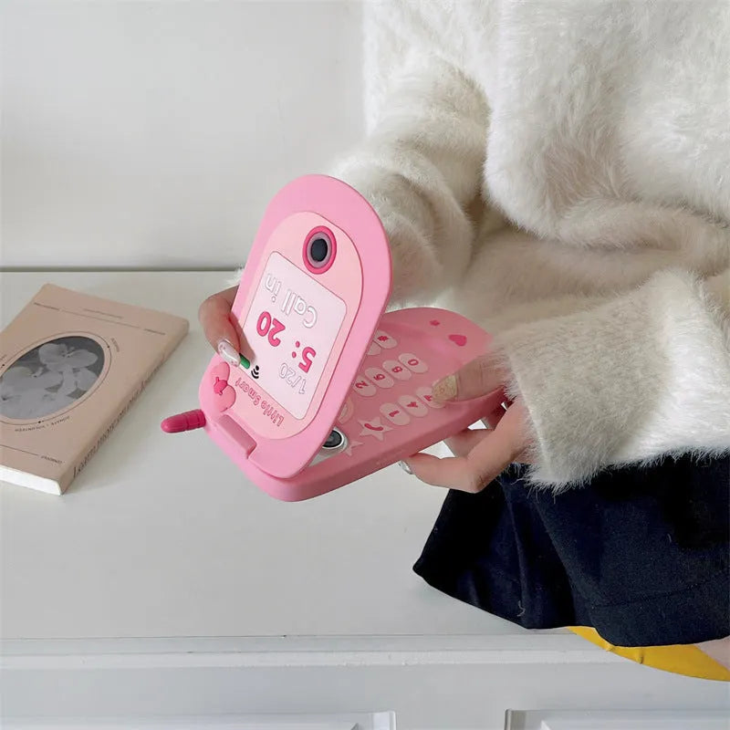 Light pink silicone flip phone case for iPhone with a built-in cosmetic mirror on the front.