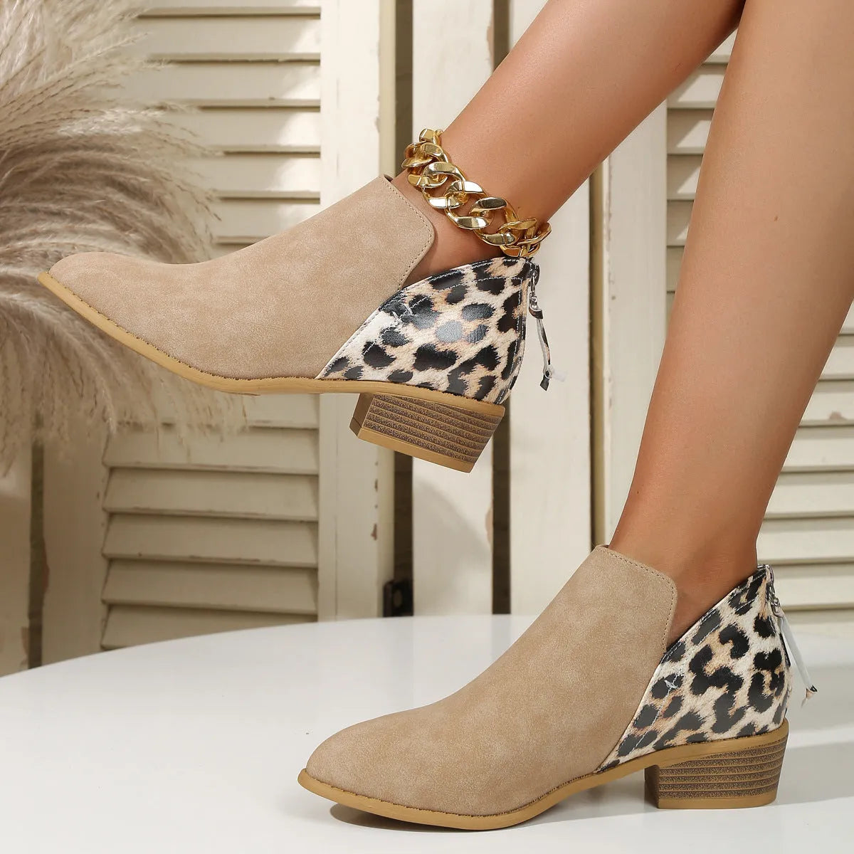 Beige leopard print suede women's ankle boots with pointed toe, chunky heel, and back zipper