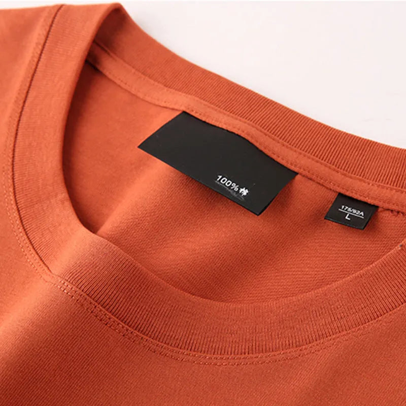 Men's solid colour cotton T-shirt with round neck and drop-shoulder sleeves in loose casual fit
