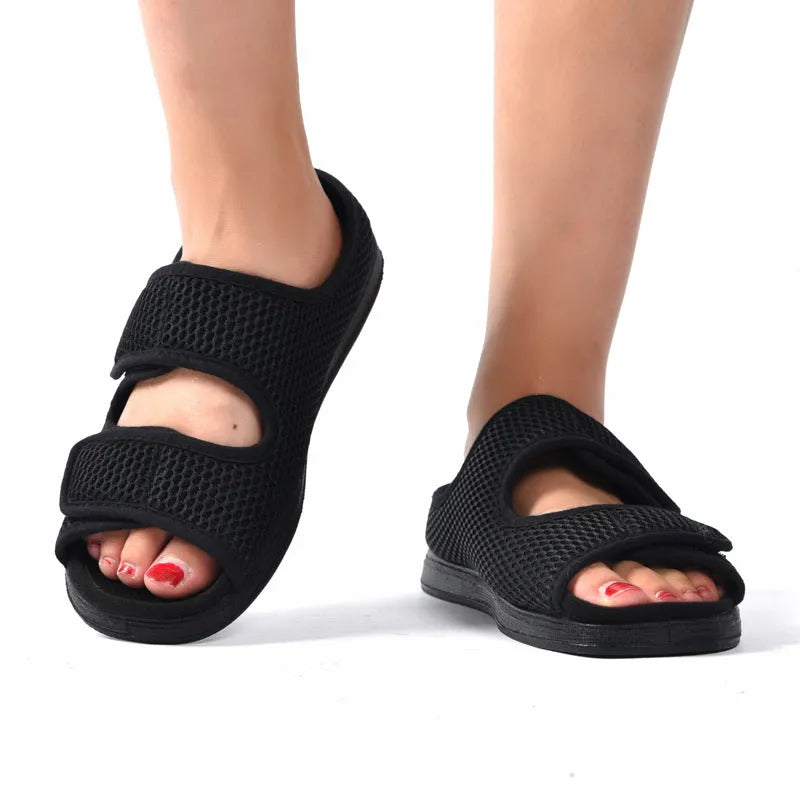 Wide adjustable foam bottom slippers with mesh upper in black, side view
