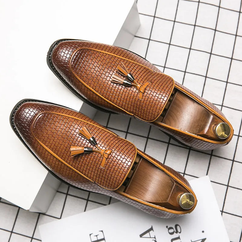 Men's black pointed toe slip-on shoes with a tassel detail on the artificial PU upper.