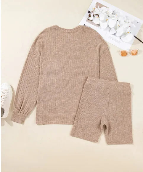 Dark khaki ribbed lantern sleeve sweater and motorcycle knit shorts set on display