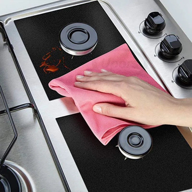 Gas stove surface protection pad made of Teflon-coated glass fibre cloth in black, measuring 27 x 27cm