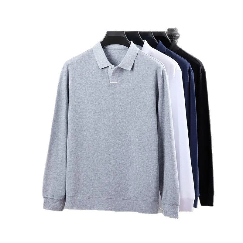 Man wearing a loose fit gray cotton polo shirt with an asymmetric lapel collar and long sleeves.