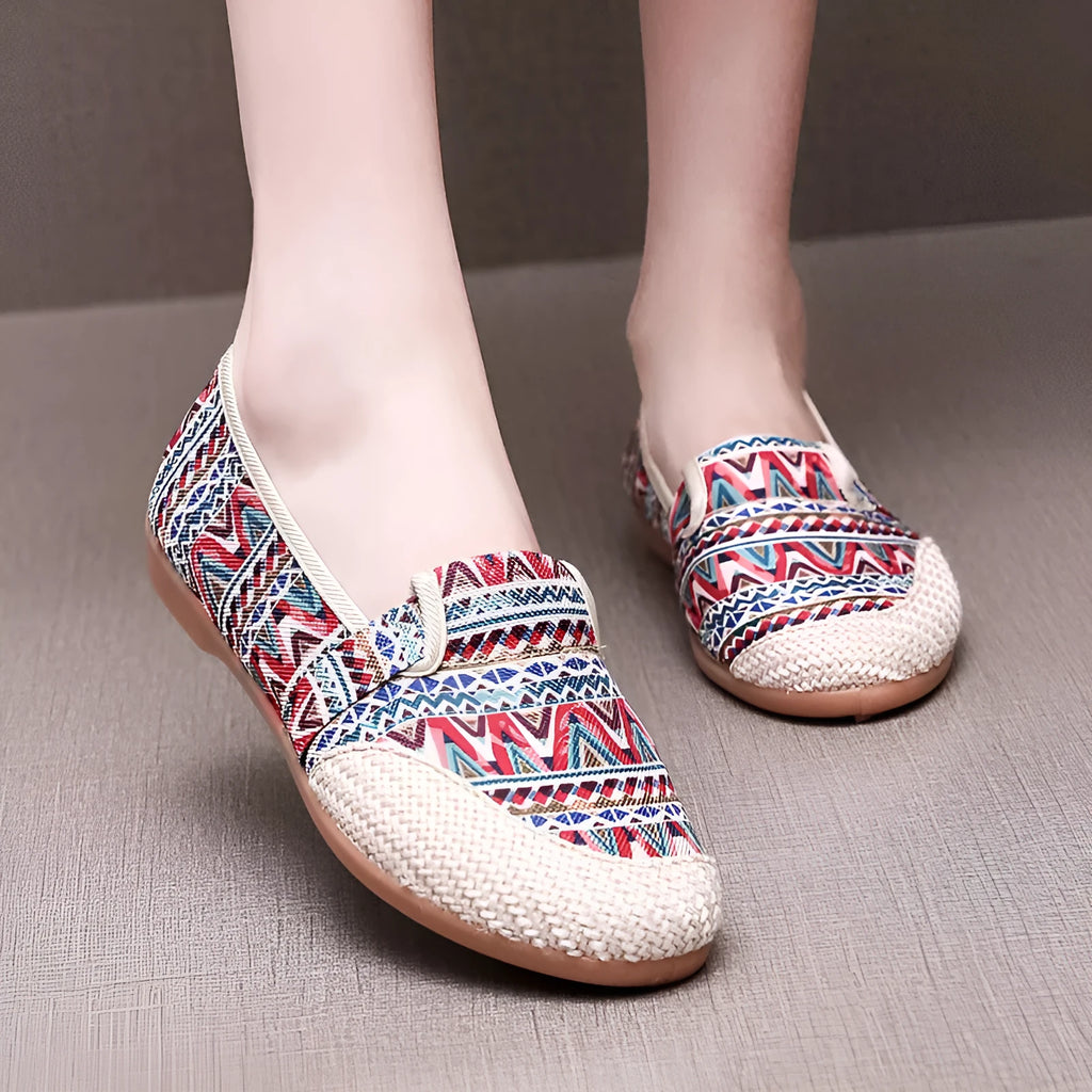 Women's ethnic style flat cloth shoes in red with colour stitching and a beef tendon sole.
