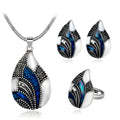 Gold water drop jewellery set with necklace, earrings, and ring on white background