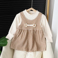 Baby girl wearing a dark coffee plaid Korean style long-sleeved dress suit set, comprising a shirt and dress.