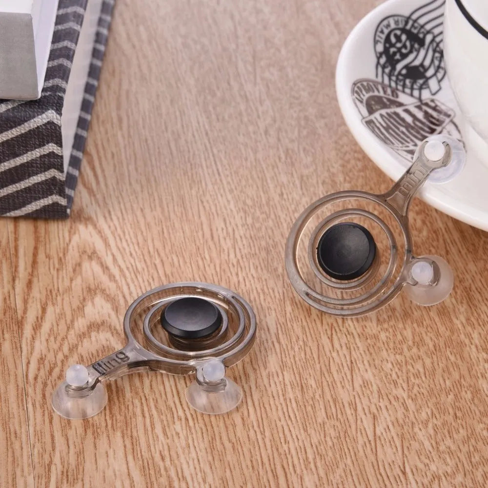 A pair of clear and black mini joysticks for mobile phone touchscreen gaming.
