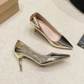 Gold and silver pointed toe slip-on stiletto heel pumps on a plain background