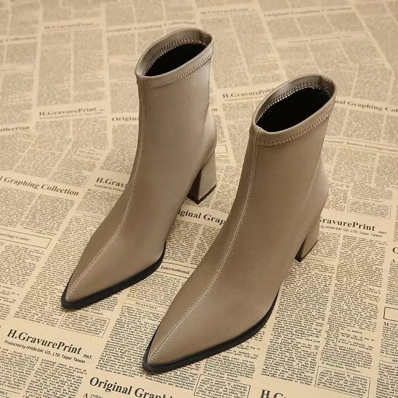 Women's khaki pointed toe Martin boots with a wedge heel on a white background.