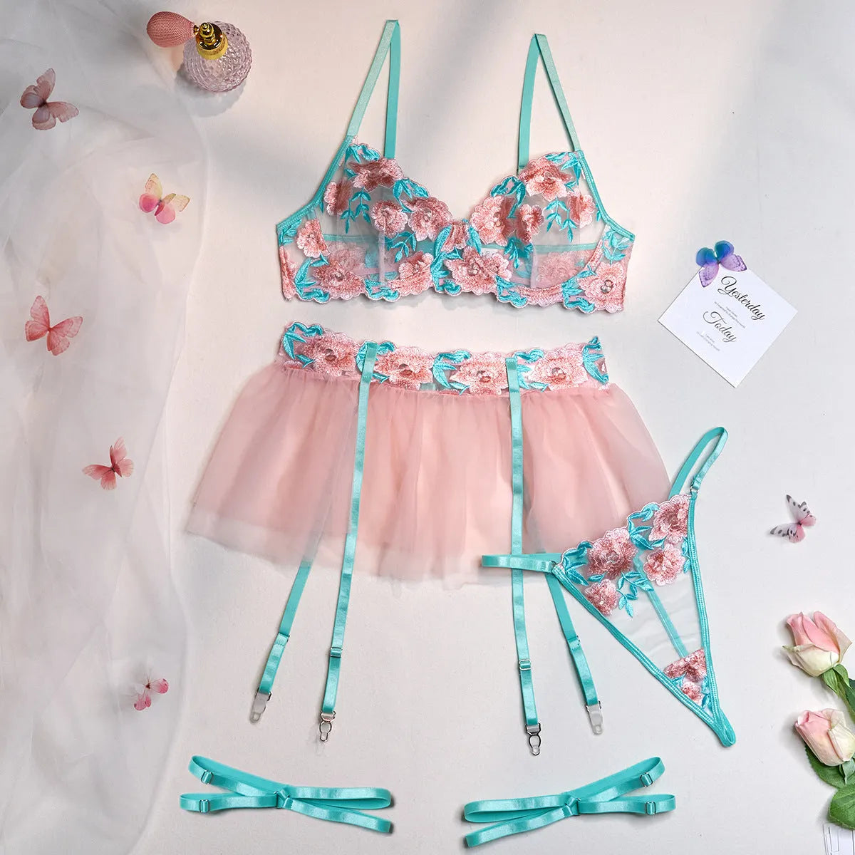 Pink women's mesh pettiskirt suit with embroidery detail, shown as a complete bikini set.