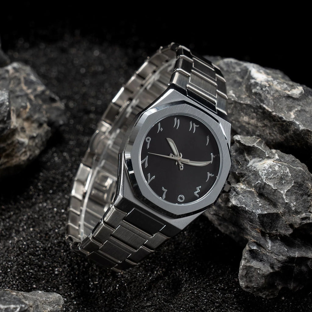 Men's business casual watch with steel bracelet showing black dial and silver scales