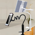 Black flexible magnalium phone and tablet mount holder with suction base on a table