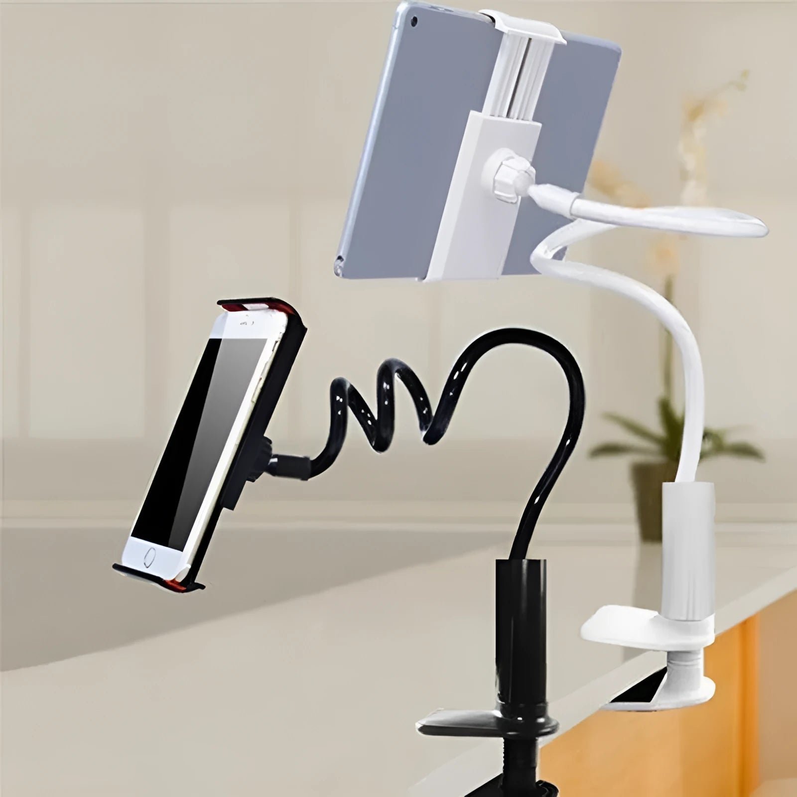 Black flexible magnalium phone and tablet mount holder with suction base on a table