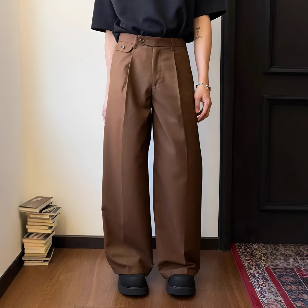 Man wearing brown straight wide-leg casual suit trousers made from a polyester blend fabric.