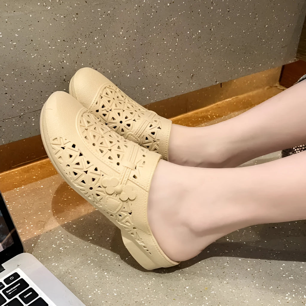Flat toe box PVC fairy style half slippers in apricot colour on a plain background.