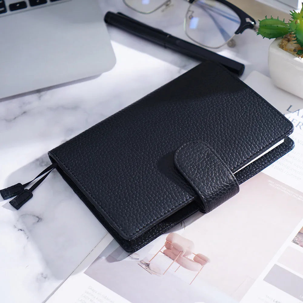 A6 leather notebook with lychee pattern cowhide cover showing loose-leaf binding in three colour options