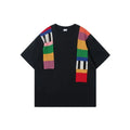 Men's loose grey cotton T-shirt with black and white patchwork letter design on chest.