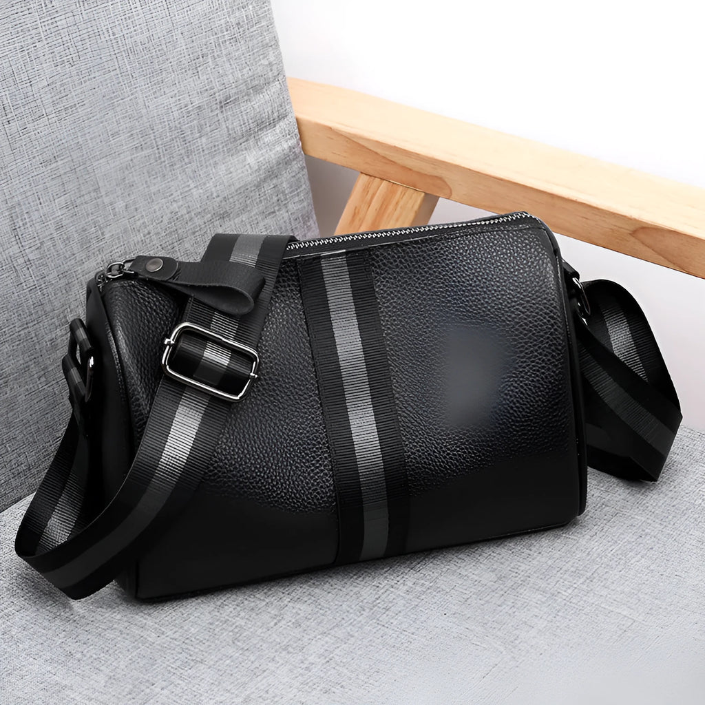 Black genuine leather one-shoulder crossbody bag showing front and interior with polyester lining